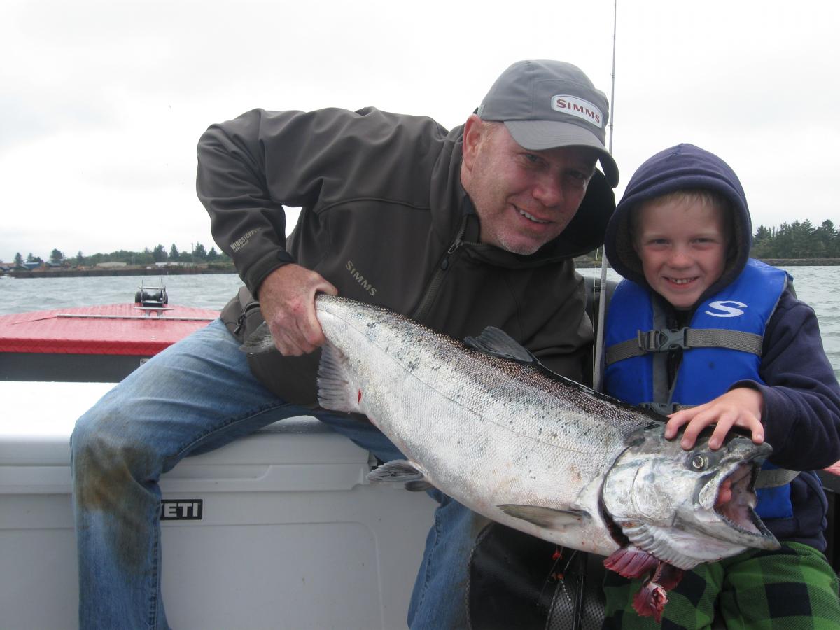 Father and Son Showing off their Trophy Salmon | Buoy 10 Fishing Guide